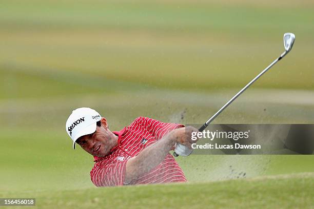 Andrew Tschudin of Australia plays a shot out of the bunker during day two of the Australia Masters at Kingston Heath Golf Club on November 16, 2012...