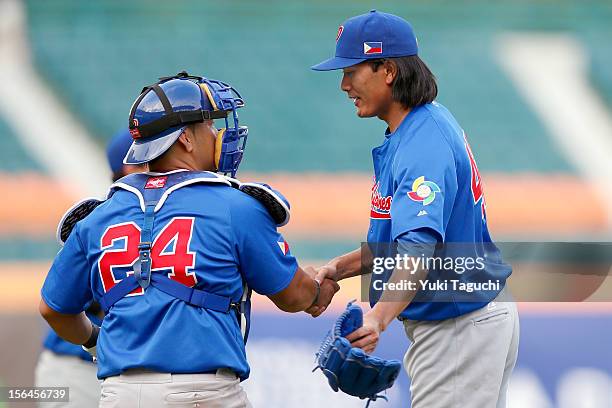 Chad Nacapoy and Geno Espineli of Team Philippines celebrate defeating Team Thailand in Game 1 of the 2013 World Baseball Classic Qualifier at...