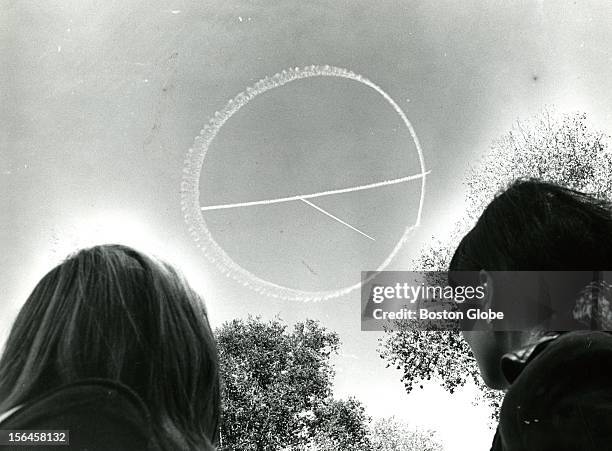 Small skywriting plane drew the peace symbol in the clear blue sky over the Boston Common while two others planes not shown here were alternately...