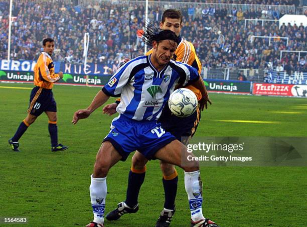 De Los Santos of Malaga and Romero of Deportivo during the match between Malaga v Deportivo in the Liga Espanyol played at the La Rosaleda Stadium,...