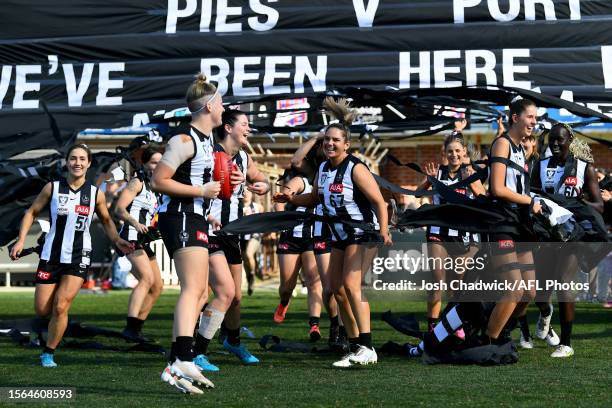 Collingwood run through the banner during the 2023 VFLW Grand Final match between the Collingwood Magpies and Port Melbourne at ETU Stadium on July...