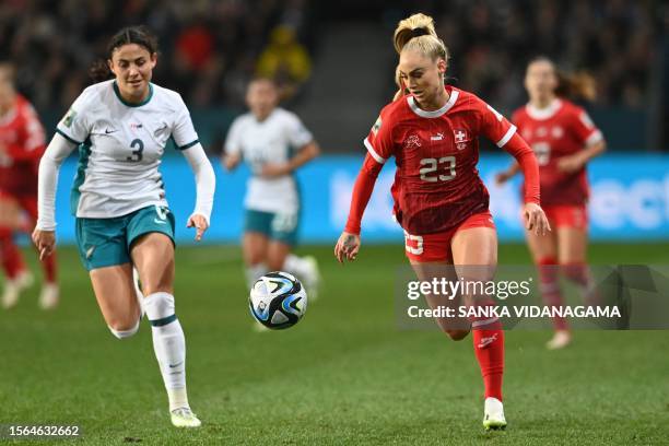 Switzerland's forward Alisha Lehmann runs with the ball next to New Zealand's defender Claudia Bunge during the Australia and New Zealand 2023...