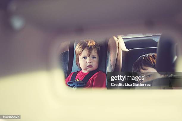 brothers in the backseat - rear view mirror stock pictures, royalty-free photos & images