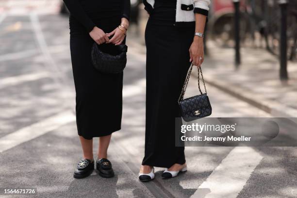 Isabelle Hartmann is seen wearing golden earrings from Yves Saint Laurent, black narrow sunglasses from Saint Laurent, a black one shoulder...