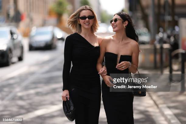 Isabelle Hartmann is seen wearing golden earrings from Yves Saint Laurent, black narrow sunglasses from Saint Laurent, a black one shoulder...