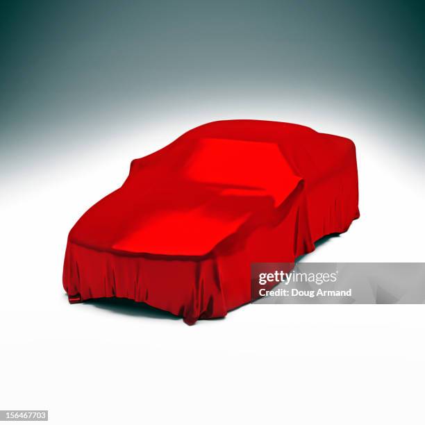 mystery luxury car under red satin cloth - mystery car stock illustrations