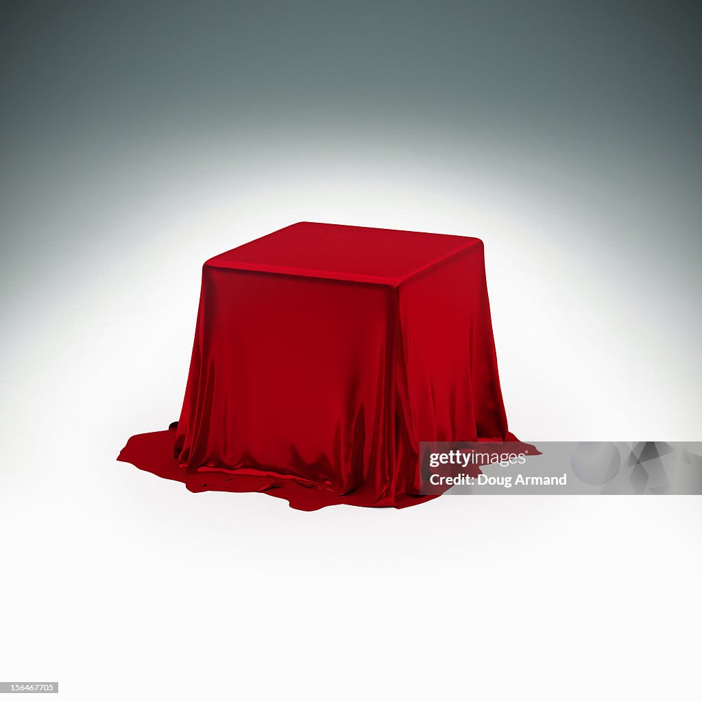 Mystery box under red silk cloth