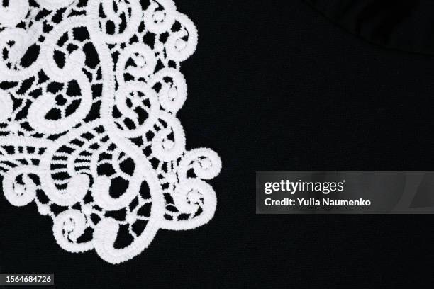 white lace on black. close-up. - black lace background stock pictures, royalty-free photos & images