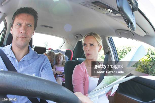 family in car, children asleep, parents with map - lost generation stock pictures, royalty-free photos & images