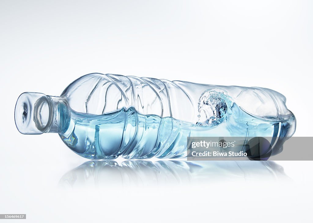 Water wave in bottle on white background