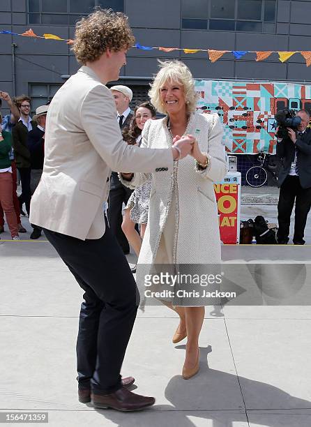 Camilla, Duchess of Cornwall dances with Sam Johnson at the Dance-O-Mat during a visit to Christchurch on November 16, 2012 in Feilding, New Zealand....