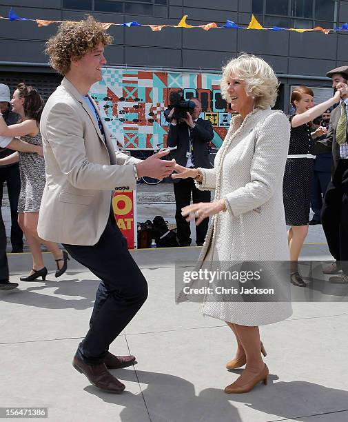 Camilla, Duchess of Cornwall dances with Sam Johnson at the Dance-O-Mat during a visit to Christchurch on November 16, 2012 in Feilding, New Zealand....