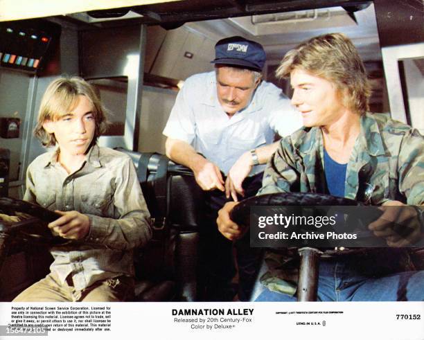 Jackie Earle Haley, George Peppard and Jan-Michael Vincent ride in a vehicle in a scene from the film 'Damnation Alley', 1977.
