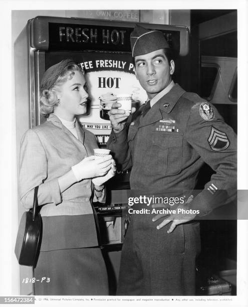 Leigh Snowden and Ray Danton having a cup of coffee in between scenes from the film 'Outside The Law', 1956.