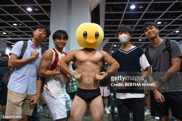 People pose with a dressed cosplayer during the annual Animation-Comic-Game in Hong Kong on July 30, 2023.