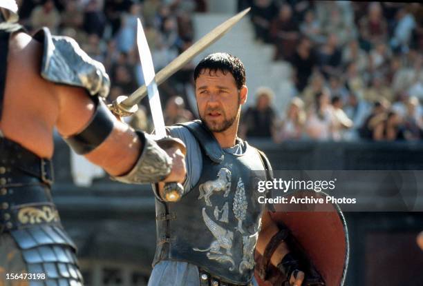 Russell Crowe facing off against another man in a scene from the film 'Gladiator', 2000.