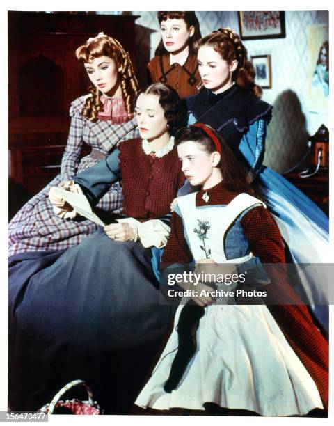 Elizabeth Taylor and Margaret O'Brien to a letter being read to them and the rest of the girls in a scene from the film 'Little Women', 1949.