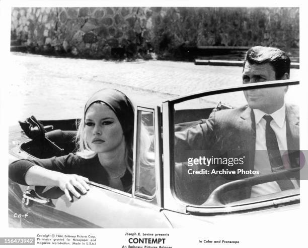 Brigitte Bardot and Jack Palance in convertible together in a scene from the film 'Contempt', 1963.