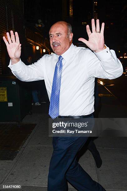 Personality Dr. Phil McGraw enters the "Late Show With David Letterman" taping at the Ed Sullivan Theater on November 15, 2012 in New York City.