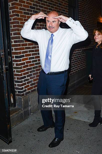 Personality Dr. Phil McGraw enters the "Late Show With David Letterman" taping at the Ed Sullivan Theater on November 15, 2012 in New York City.