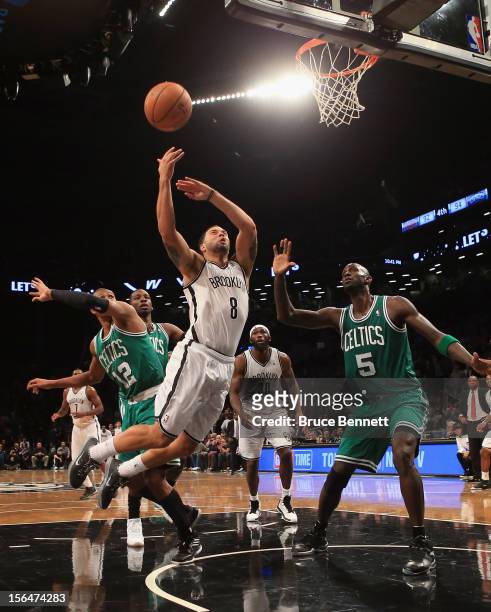 Deron Williams of the Brooklyn Nets is fouled by Leandro Barbosa of the Boston Celtics at the Barclays Center on November 15, 2012 in the Brooklyn...