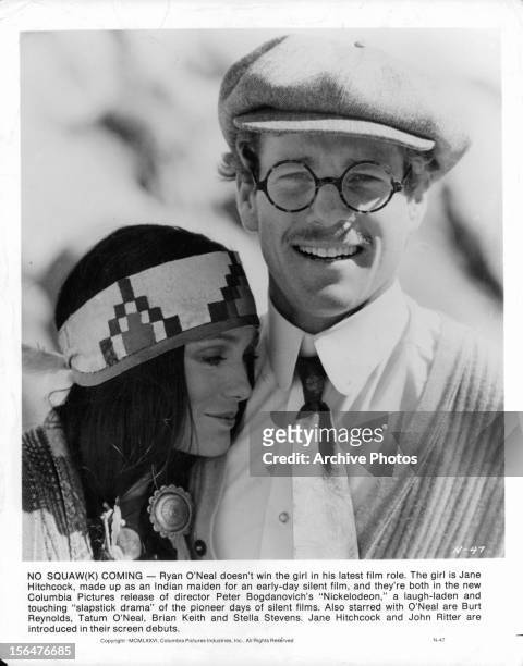Jane Hitchcock leans on Ryan O'Neal in a publicity portrait for the film 'Nickelodeon', 1976.