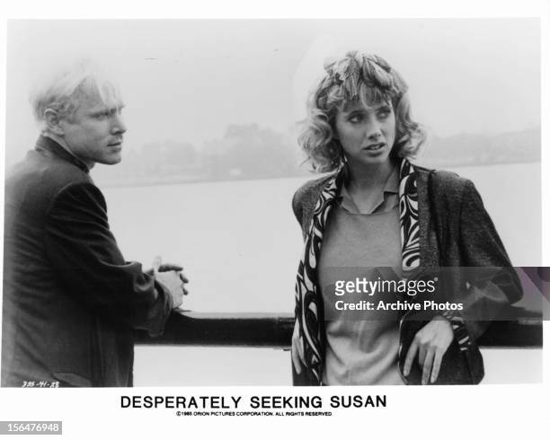 Actors Will Patton and Rosanna Arquette lean against a railing in a scene from the film 'Desperately Seeking Susan', 1985.