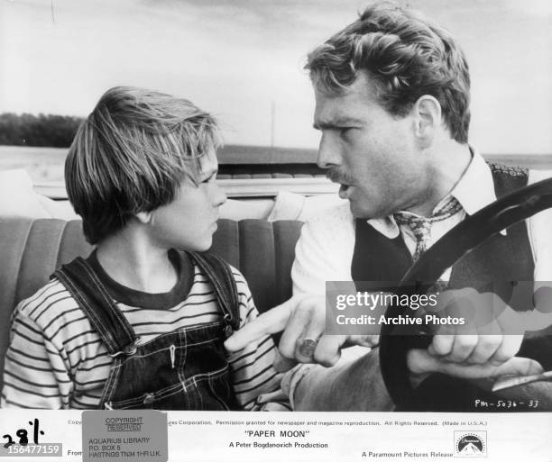 Ryan O'Neal drives while having a serious discusses with Tatum O'Neal in a scene from the film 'Paper Moon', 1973.