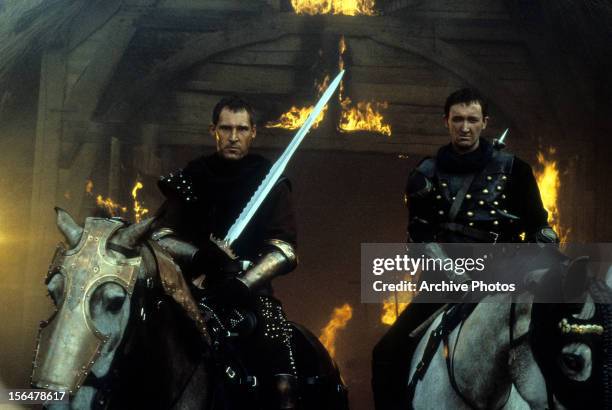 Ben Cross on horseback with another man in a scene from the film 'First Knight', 1995.