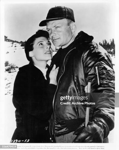 Anne Bancroft looks to Aldo Ray in a scene from the film 'Nightfall', 1957.