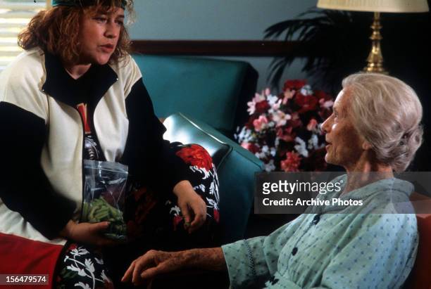 Kathy Bates sitting on couch with Jessica Tandy in a scene from the film 'Fried Green Tomatoes', 1991.