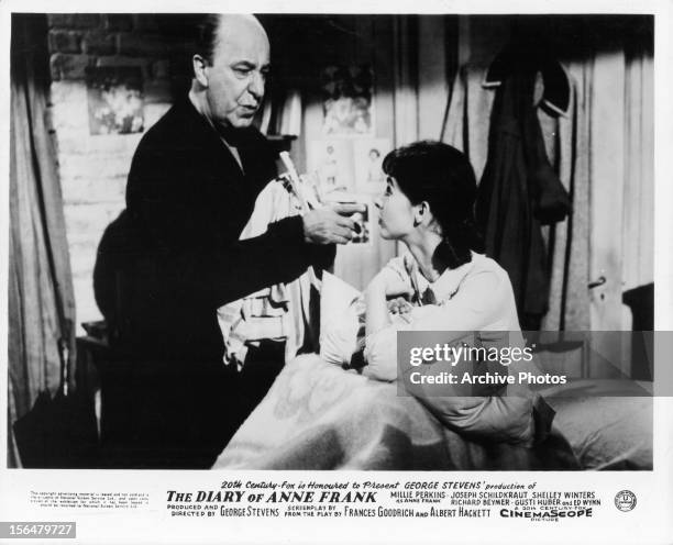 Ed Wynn takes care of Millie Perkins in a scene from the film 'The Diary Of Anne Frank', 1959.