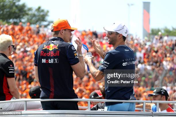 Daniel Ricciardo of Australia and Scuderia AlphaTauri and Max Verstappen of the Netherlands and Oracle Red Bull Racing talk on the drivers parade...