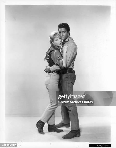 Barbara Eden is held by Elvis Presley in publicity portrait for the film 'Flaming Star', 1960.