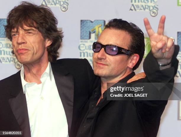 British singer Mike Jagger and Bono, the lead singer of Irish group U2, pose for photographers during the MTV Europe Awards at The Point in Dublin 11...