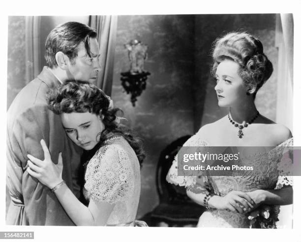 Herbert Marshall holds Teresa Wright while Bette Davis looks at him in a scene from the film 'The Little Foxes', 1941.