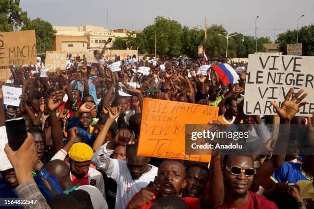 Coup supporters unfurl a Russian flag as they take to the streets after the army seized power in Niamey, Niger on July 30, 2023.