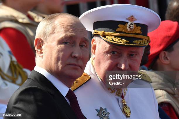 Russian President Vladimir Putin, accompanied by Commander-in-Chief of the Russian Navy, Admiral Nikolai Yevmenov, attends the Navy Day parade in...