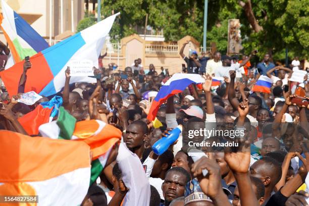 Coup supporters unfurl a Russian flag as they take to the streets after the army seized power in Niamey, Niger on July 30, 2023.