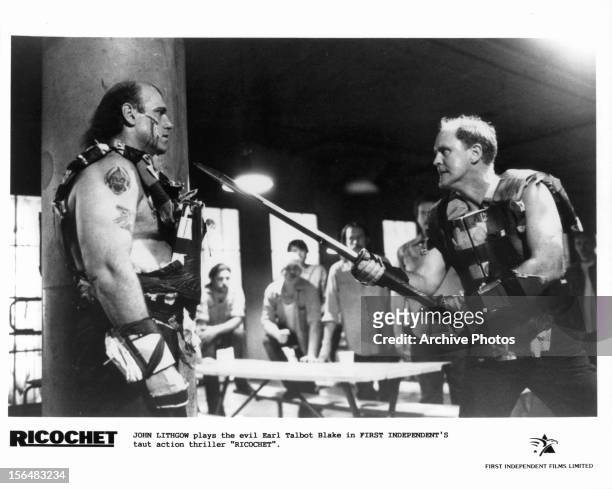 Jesse Ventura is intimidated by a knife yielding John Lithgow in a scene from the film 'Ricochet', 1991.