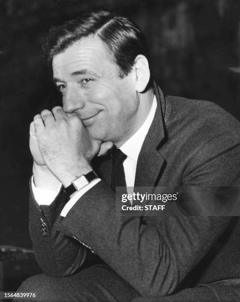French actor-singer Yves Montand is all smile as he waits outside the Savoy Hotel, 22 February 1962, in London. Montand has been engaged to perform...