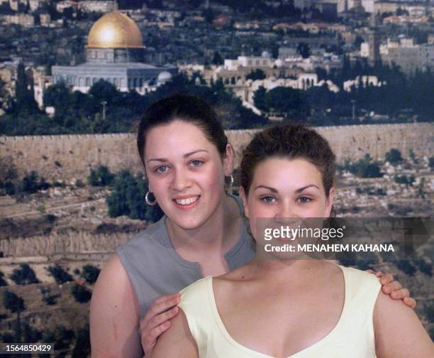 The Mullan sisters, Bronagh and Karen, who are Ireland's entry in the 1999 Eurovision song contest, pose for photographers in front of a picture of...