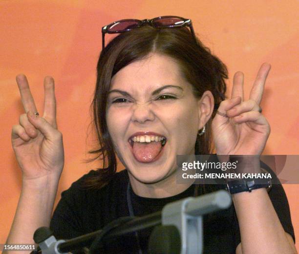 Bobbie Singer, Austria's entry to the 1999 Eurovision song contest, makes the V-sign during a press conference in Jerusalem 25 May 1999. Bobbie will...