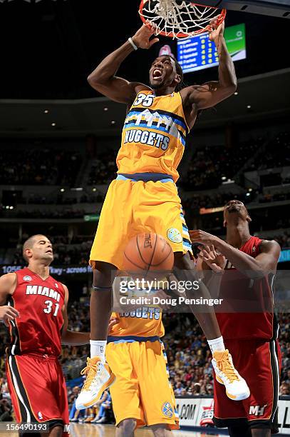 Kenneth Faried of the Denver Nuggets dunks the ball against Chris Bosh of the Miami Heat at the Pepsi Center on November 15, 2012 in Denver,...