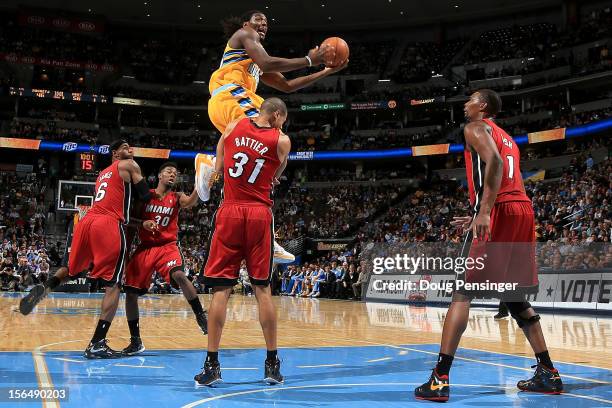 Kenneth Faried of the Denver Nuggets is charged with an offensive foul as he collides with Shane Battier of the Miami Heat at the Pepsi Center on...