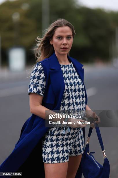 Cheyenne Pahde is seen wearing a complete Riani outfit, consisting of a white/blue patterned two-piece with shorts and tee, a sleeveless long blue...