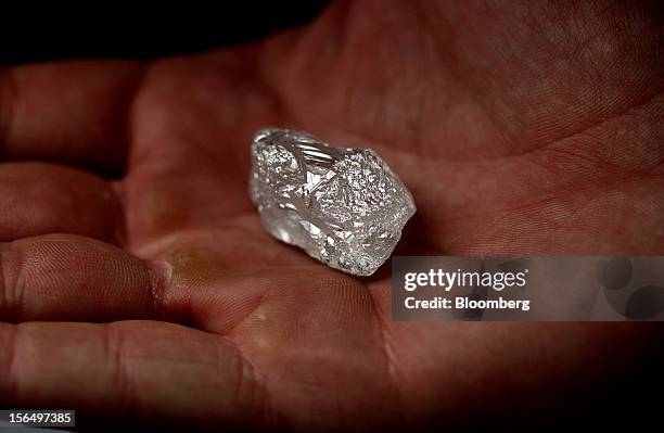 An employee displays a large uncut diamond in this arranged photograph at DTC Botswana, a unit of De Beers, in Gaborone, Botswana, on Thursday, Oct....