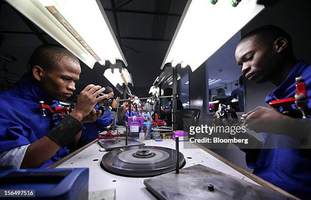 Employees prepare diamonds for polishing on a polishing wheel at the Shrenuj Botswana Ltd. Sightholder office in Gaborone, Botswana, on Thursday,...