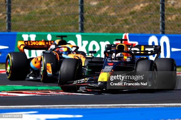 Max Verstappen of the Netherlands driving the Oracle Red Bull Racing RB19 leads Oscar Piastri of Australia driving the McLaren MCL60 Mercedes during...