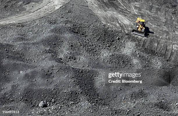 Digger moves diamond-bearing kimberlite rock at the base of the Jwaneng mine, operated by the Debswana Diamond Co., a joint venture between De Beers...